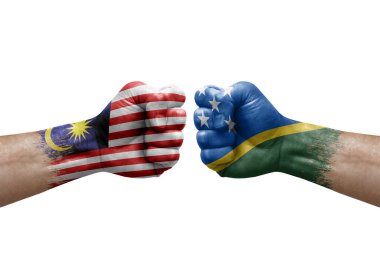 Two hands punch to each others on white background. Country flags painted fists, conflict crisis concept between malaysia and solomon islands