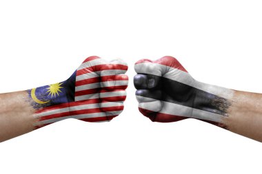 Two hands punch to each others on white background. Country flags painted fists, conflict crisis concept between malaysia and thailand