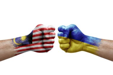 Two hands punch to each others on white background. Country flags painted fists, conflict crisis concept between malaysia and ukraine
