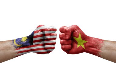 Two hands punch to each others on white background. Country flags painted fists, conflict crisis concept between malaysia and vietnam