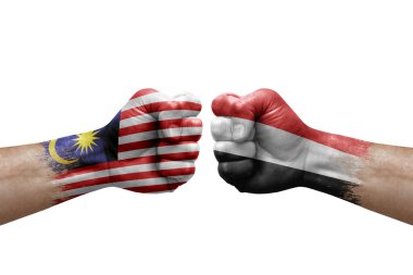 Two hands punch to each others on white background. Country flags painted fists, conflict crisis concept between malaysia and yemen
