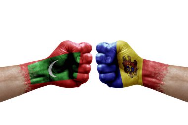 Two hands punch to each others on white background. Country flags painted fists, conflict crisis concept between maldives and moldova