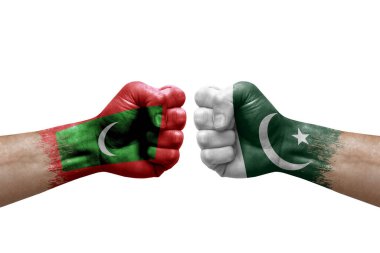 Two hands punch to each others on white background. Country flags painted fists, conflict crisis concept between maldives and pakistan