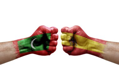 Two hands punch to each others on white background. Country flags painted fists, conflict crisis concept between maldives and spain