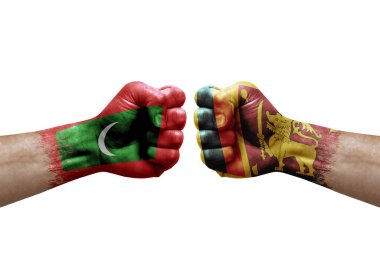Two hands punch to each others on white background. Country flags painted fists, conflict crisis concept between maldives and sri lanka