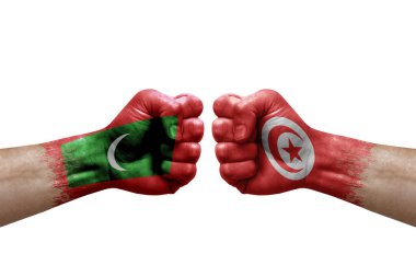 Two hands punch to each others on white background. Country flags painted fists, conflict crisis concept between maldives and tunisia