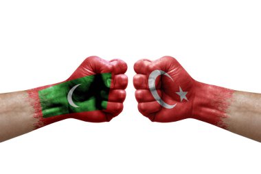 Two hands punch to each others on white background. Country flags painted fists, conflict crisis concept between maldives and turkey