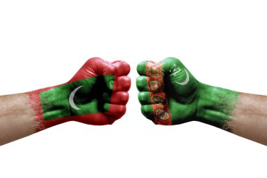 Two hands punch to each others on white background. Country flags painted fists, conflict crisis concept between maldives and turkmenistan