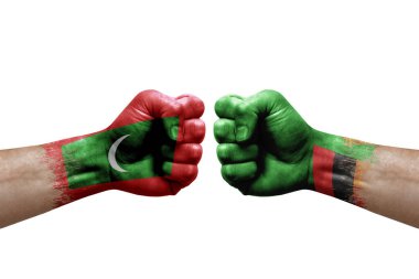 Two hands punch to each others on white background. Country flags painted fists, conflict crisis concept between maldives and zambia