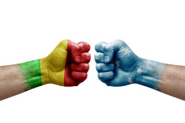 Two hands punch to each others on white background. Country flags painted fists, conflict crisis concept between mali and micronesia