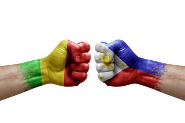 Two hands punch to each others on white background. Country flags painted fists, conflict crisis concept between mali and philippines