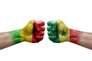 Two hands punch to each others on white background. Country flags painted fists, conflict crisis concept between mali and senegal