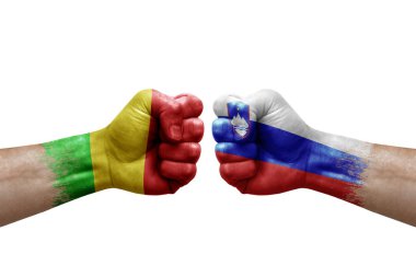 Two hands punch to each others on white background. Country flags painted fists, conflict crisis concept between mali and slovenia