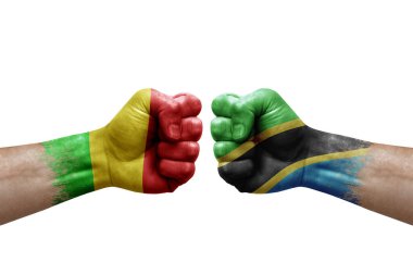 Two hands punch to each others on white background. Country flags painted fists, conflict crisis concept between mali and tanzania