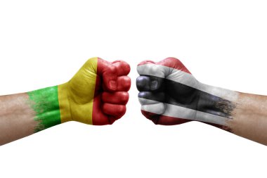 Two hands punch to each others on white background. Country flags painted fists, conflict crisis concept between mali and thailand