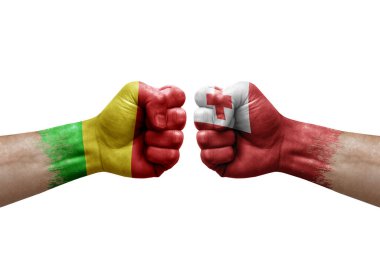Two hands punch to each others on white background. Country flags painted fists, conflict crisis concept between mali and tonga