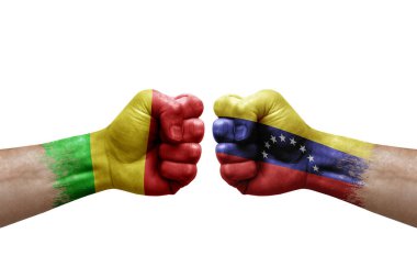 Two hands punch to each others on white background. Country flags painted fists, conflict crisis concept between mali and venezuela