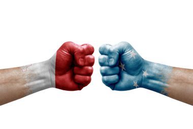 Two hands punch to each others on white background. Country flags painted fists, conflict crisis concept between malta and micronesia
