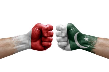 Two hands punch to each others on white background. Country flags painted fists, conflict crisis concept between malta and pakistan