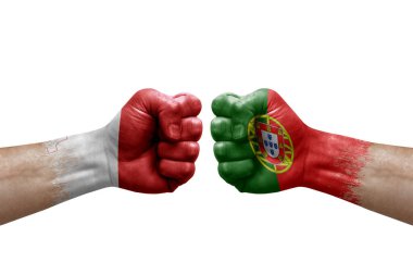 Two hands punch to each others on white background. Country flags painted fists, conflict crisis concept between malta and portugal