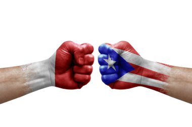 Two hands punch to each others on white background. Country flags painted fists, conflict crisis concept between malta and puerto rico