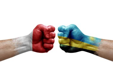 Two hands punch to each others on white background. Country flags painted fists, conflict crisis concept between malta and rwanda