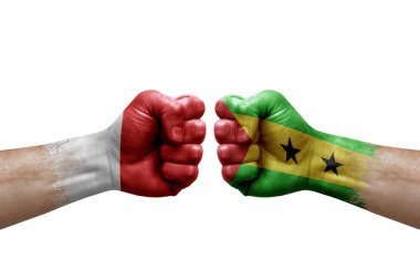 Two hands punch to each others on white background. Country flags painted fists, conflict crisis concept between malta and sao tome and principe