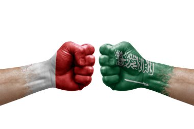 Two hands punch to each others on white background. Country flags painted fists, conflict crisis concept between malta and saudi arabia