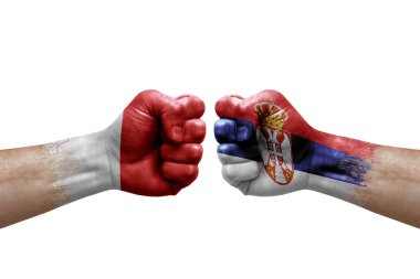 Two hands punch to each others on white background. Country flags painted fists, conflict crisis concept between malta and serbia