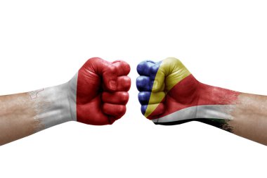 Two hands punch to each others on white background. Country flags painted fists, conflict crisis concept between malta and seychelles