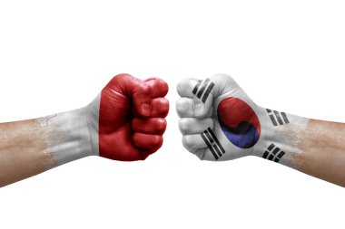 Two hands punch to each others on white background. Country flags painted fists, conflict crisis concept between malta and south korea