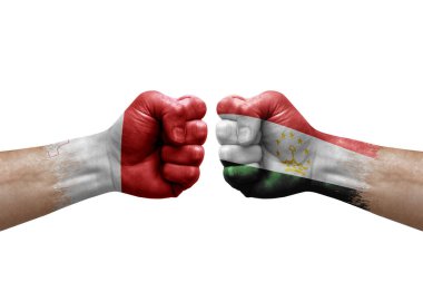 Two hands punch to each others on white background. Country flags painted fists, conflict crisis concept between malta and tajikistan