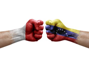 Two hands punch to each others on white background. Country flags painted fists, conflict crisis concept between malta and venezuela