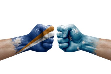 Two hands punch to each others on white background. Country flags painted fists, conflict crisis concept between marshall islands and micronesia