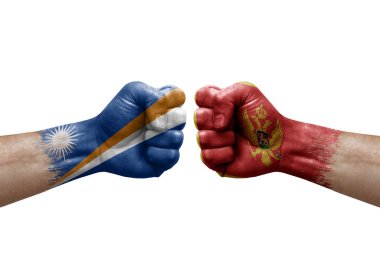 Two hands punch to each others on white background. Country flags painted fists, conflict crisis concept between marshall islands and montenegro