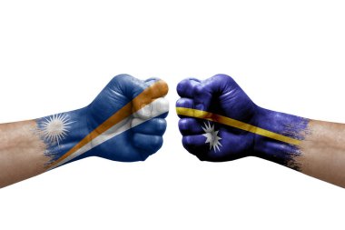Two hands punch to each others on white background. Country flags painted fists, conflict crisis concept between marshall islands and nauru
