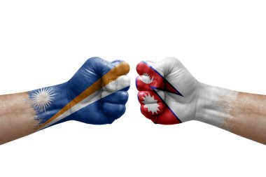 Two hands punch to each others on white background. Country flags painted fists, conflict crisis concept between marshall islands and nepal