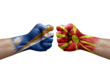 Two hands punch to each others on white background. Country flags painted fists, conflict crisis concept between marshall islands and north macedonia