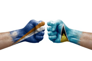 Two hands punch to each others on white background. Country flags painted fists, conflict crisis concept between marshall islands and saint lucia