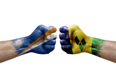 Two hands punch to each others on white background. Country flags painted fists, conflict crisis concept between marshall islands and saint vincent and the grenadines