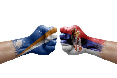 Two hands punch to each others on white background. Country flags painted fists, conflict crisis concept between marshall islands and serbia