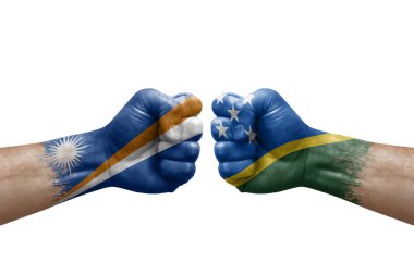 Two hands punch to each others on white background. Country flags painted fists, conflict crisis concept between marshall islands and solomon islands