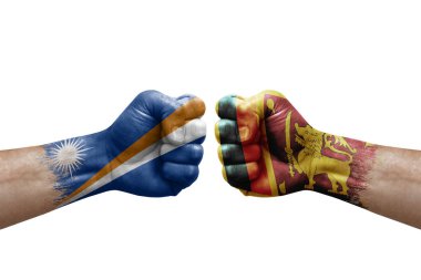 Two hands punch to each others on white background. Country flags painted fists, conflict crisis concept between marshall islands and sri lanka