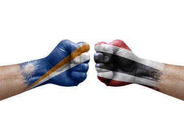 Two hands punch to each others on white background. Country flags painted fists, conflict crisis concept between marshall islands and thailand