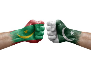 Two hands punch to each others on white background. Country flags painted fists, conflict crisis concept between mauritania and pakistan