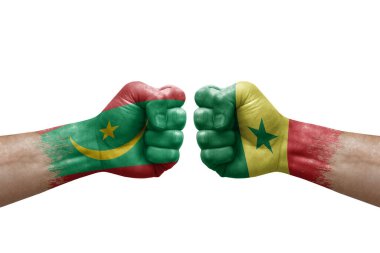 Two hands punch to each others on white background. Country flags painted fists, conflict crisis concept between mauritania and senegal