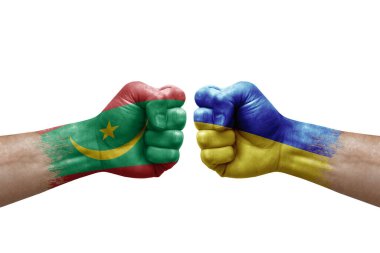 Two hands punch to each others on white background. Country flags painted fists, conflict crisis concept between mauritania and ukraine