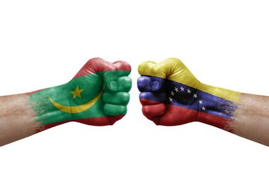 Two hands punch to each others on white background. Country flags painted fists, conflict crisis concept between mauritania and venezuela