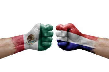 Two hands punch to each others on white background. Country flags painted fists, conflict crisis concept between mexico and netherlands