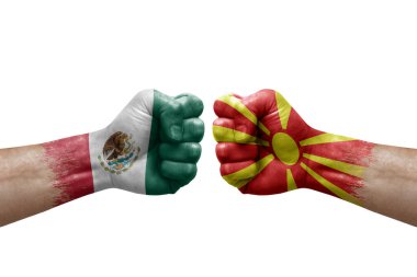 Two hands punch to each others on white background. Country flags painted fists, conflict crisis concept between mexico and north macedonia